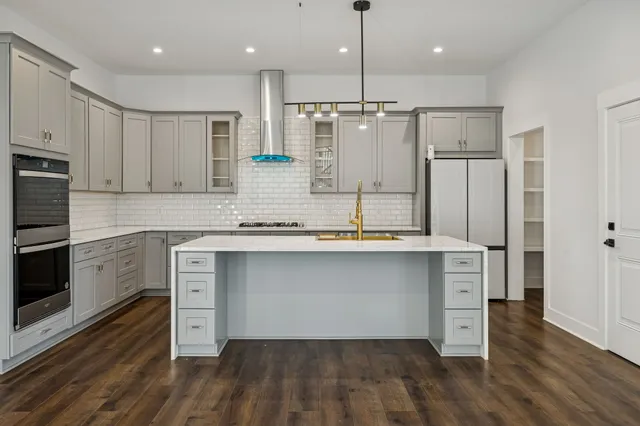 a living room with a fireplace and wooden floor