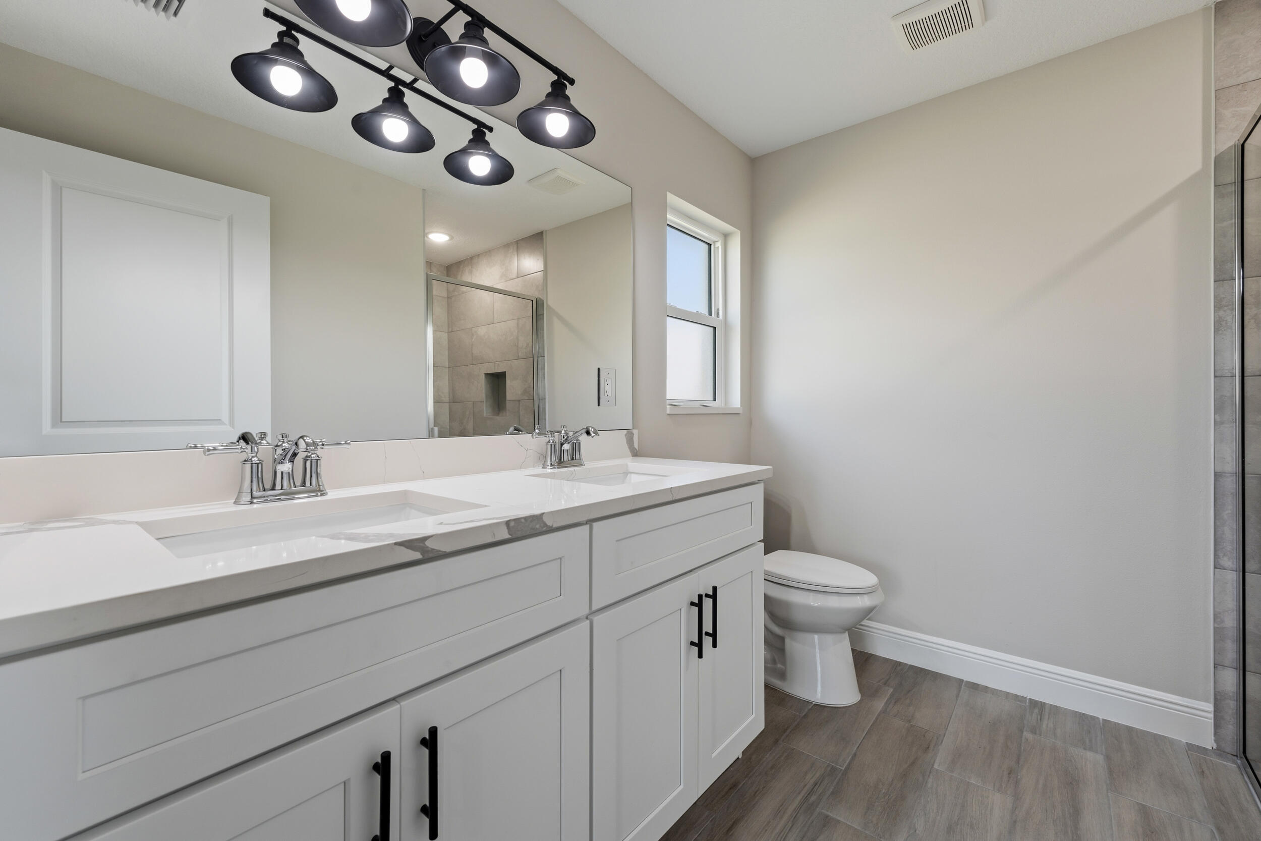 4335 Southwest 15th Way Okeechobee, FL 34974 - Photo 18 of 33 a bathroom with a toilet sink and mirror