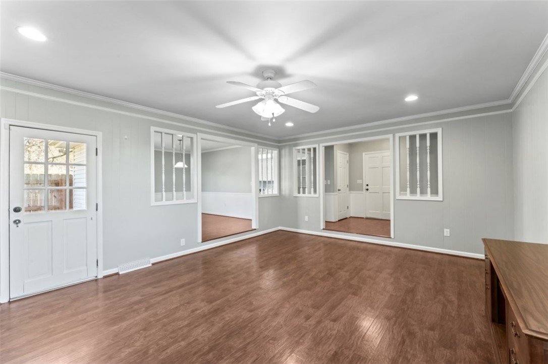 304 Stonehaven Drive Anderson, SC 29625 - Photo 4 of 19 Hardwood floors and bright recessed lighting create an inviting atmosphere in this flexible living space.