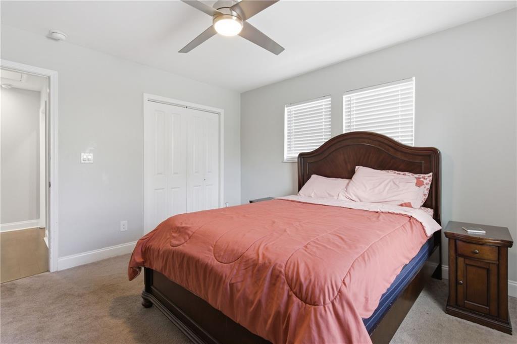1690 Ware Avenue Atlanta, GA 30344 - Photo 12 of 25 a bedroom with a bed and a chandelier
