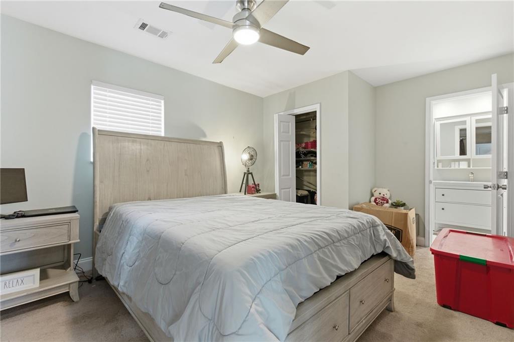 1690 Ware Avenue Atlanta, GA 30344 - Photo 13 of 25 a bedroom with a bed and a chandelier