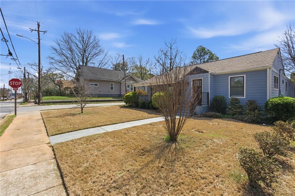 1690 Ware Avenue Atlanta, GA 30344 - Photo 24 of 25 a view of a white house with a yard and potted plants