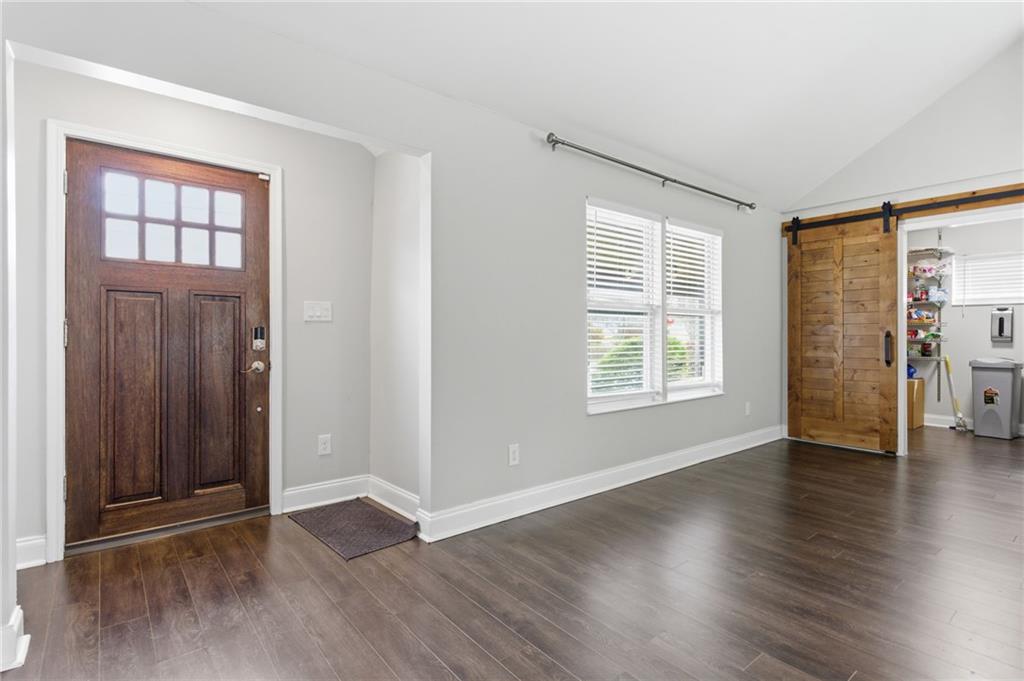 1690 Ware Avenue Atlanta, GA 30344 - Photo 3 of 25 an empty room with wooden floor and windows