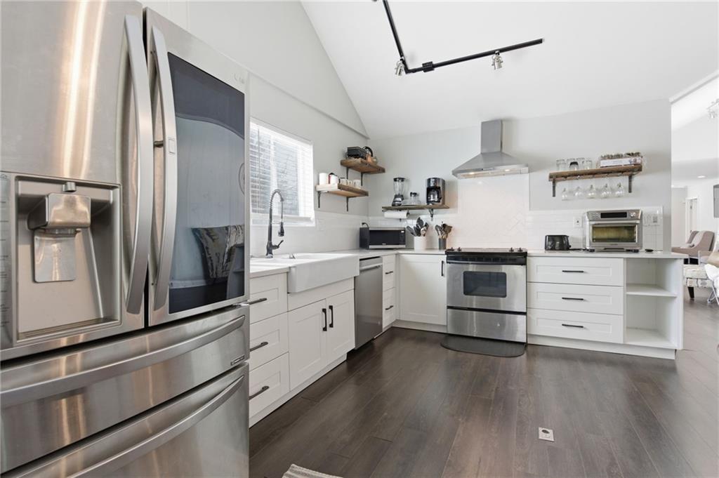 1690 Ware Avenue Atlanta, GA 30344 - Photo 6 of 25 a kitchen with stainless steel appliances a stove a sink and a refrigerator