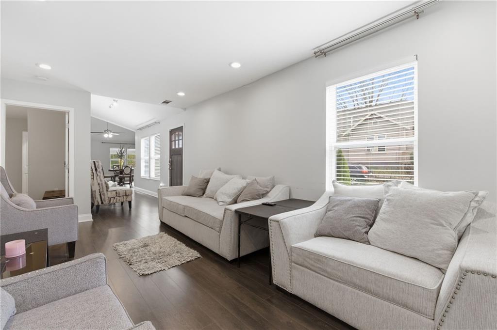 1690 Ware Avenue Atlanta, GA 30344 - Photo 8 of 25 a living room with furniture a fireplace and a flat screen tv
