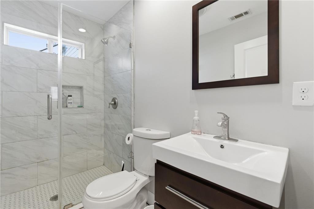 1690 Ware Avenue Atlanta, GA 30344 - Photo 10 of 25 a bathroom with a sink a toilet and shower