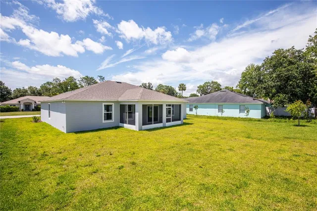 a front view of a house with yard and swimming pool