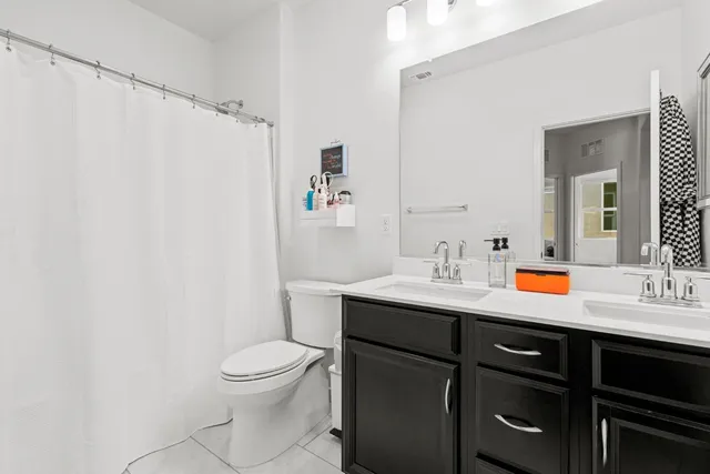 a bathroom with double sink and a mirror