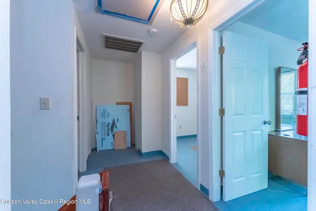 a view of a hallway with wooden floor and closet