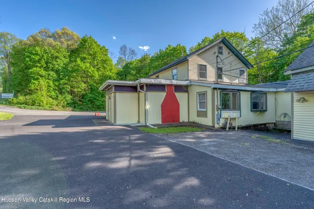 a view of a house with a yard and garage