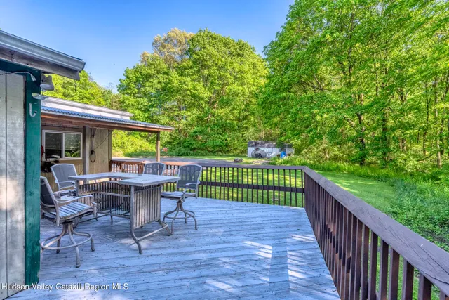 a view of a chairs and table on the wooden deck