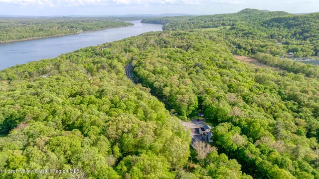 a view of a green field with a lake