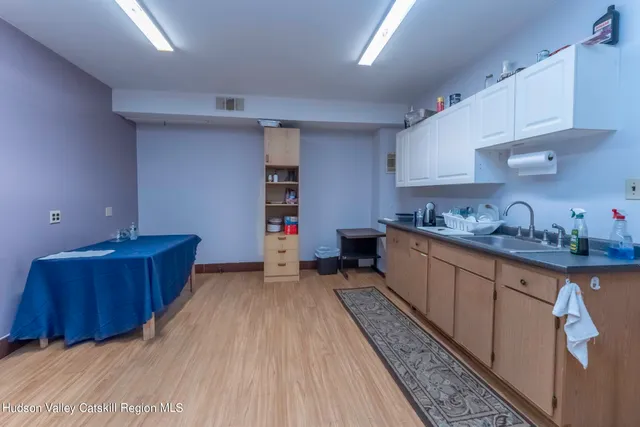 a kitchen with granite countertop a sink dishwasher stove and cabinets