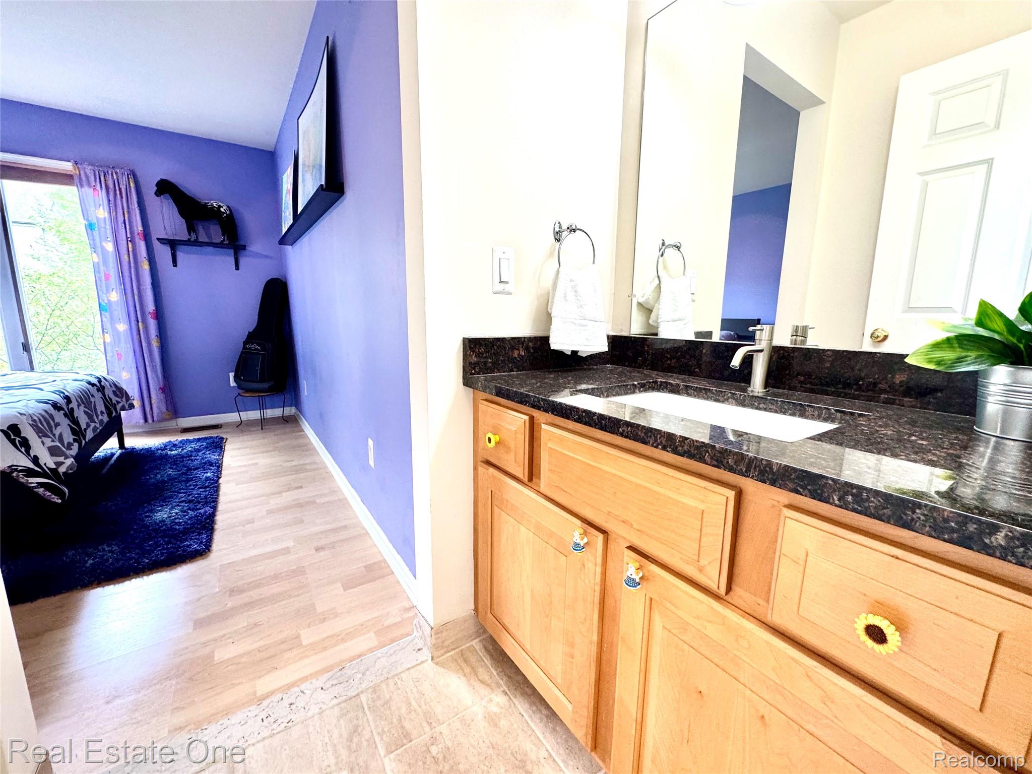 1215 Letica Drive Rochester, MI 48307 - Photo 21 of 43 Bathroom with vanity, light wood-style floors, and ensuite bath