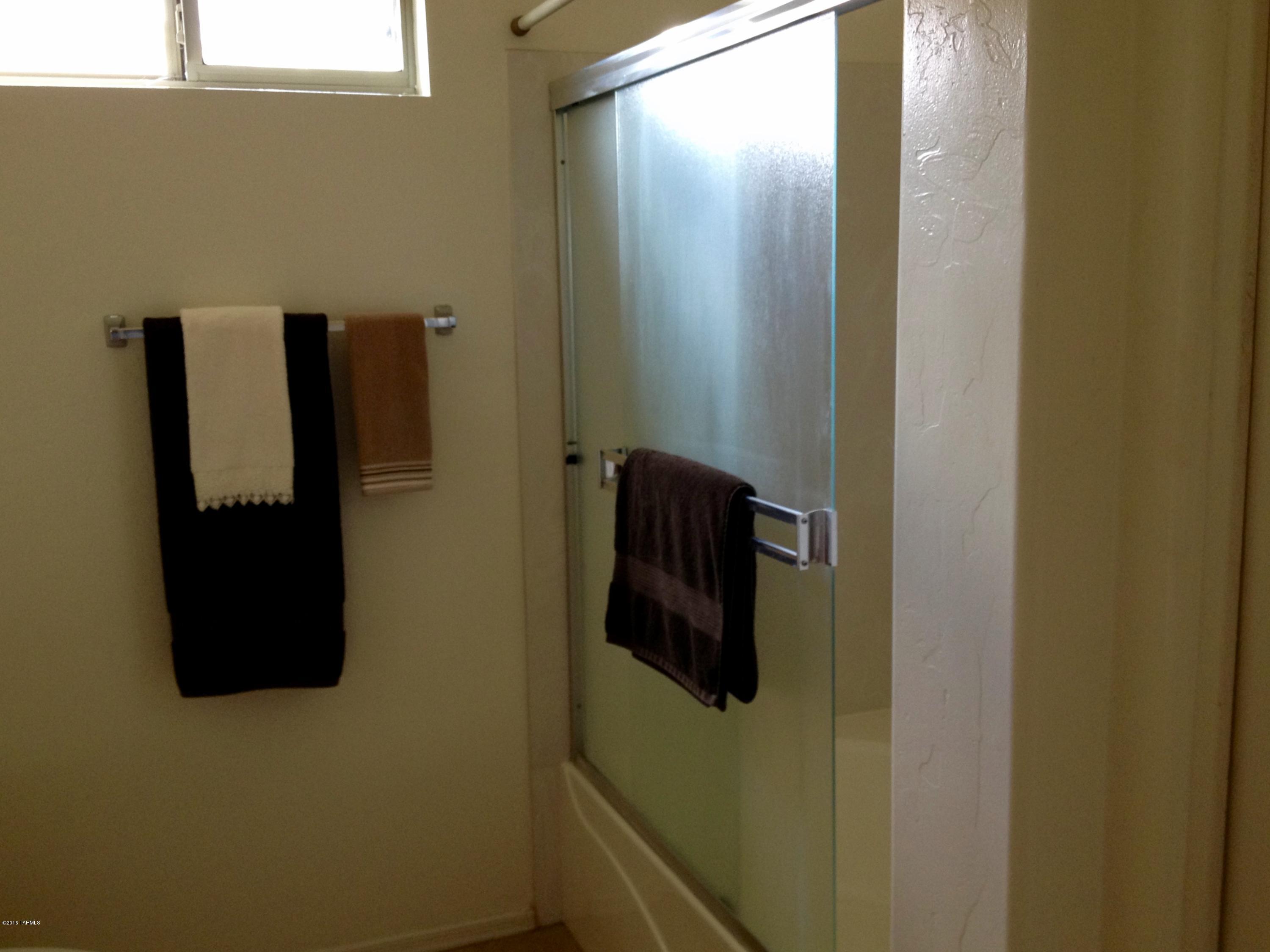 7931 North Iron Ridge Drive Tucson, AZ 85743 - Photo 14 of 21 a bathroom with a shower and a sink