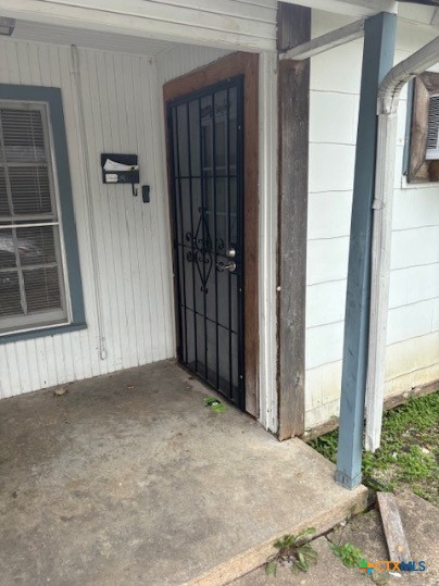 1106 Middleton Street Killeen, TX 76541 - Photo 3 of 9 a view of an empty room with wooden floor and a window