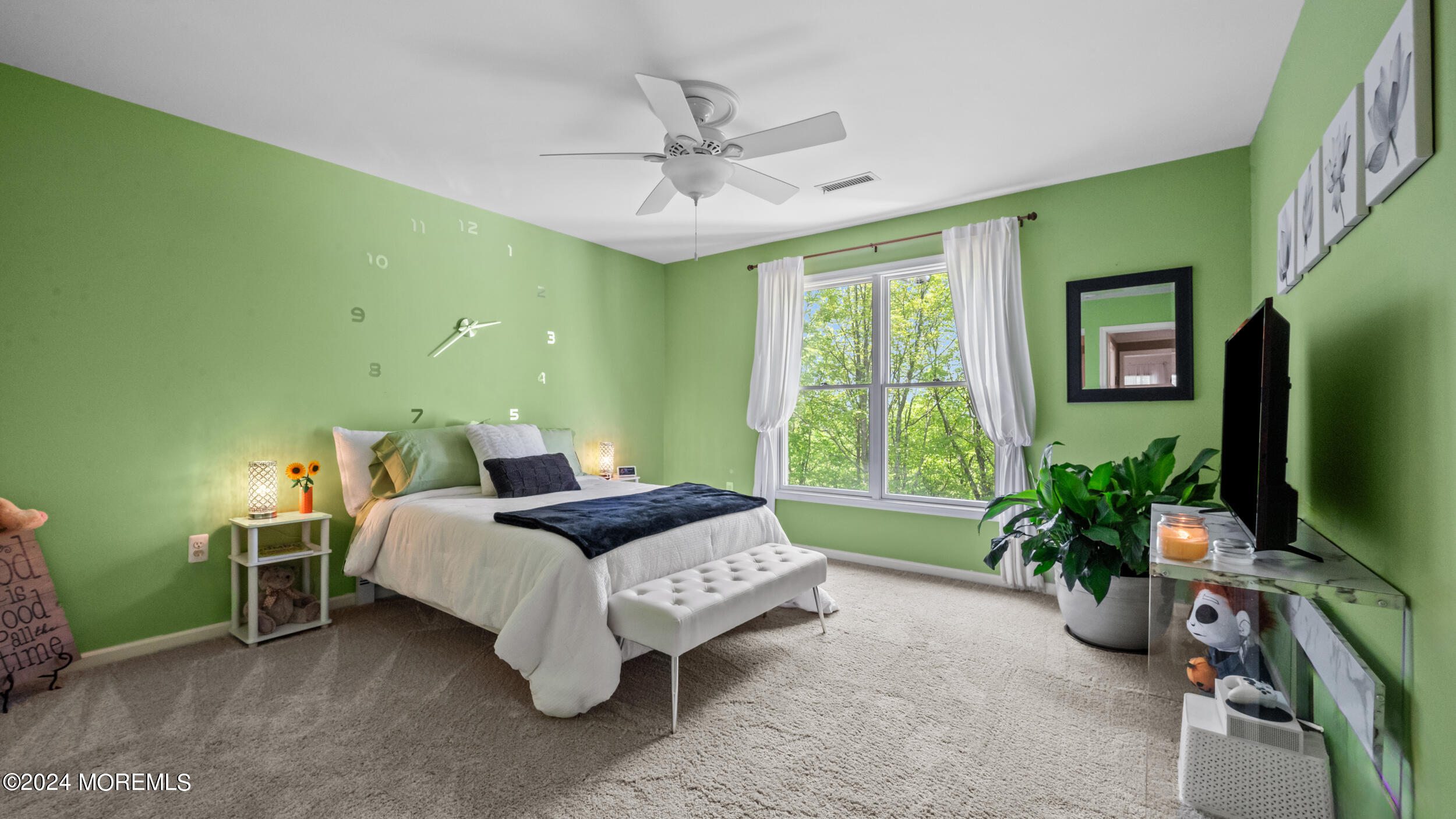 55 Tower Road Cream Ridge, NJ 08514 - Photo 31 of 47 a bedroom with a bed a chandelier and a flat screen tv