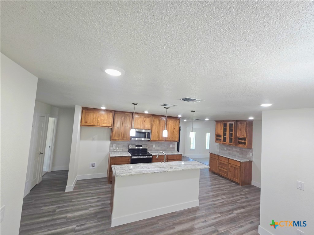 132 County Road 4765 Kempner, TX 76539 - Photo 15 of 36 a view of kitchen with refrigerator stove microwave and cabinets