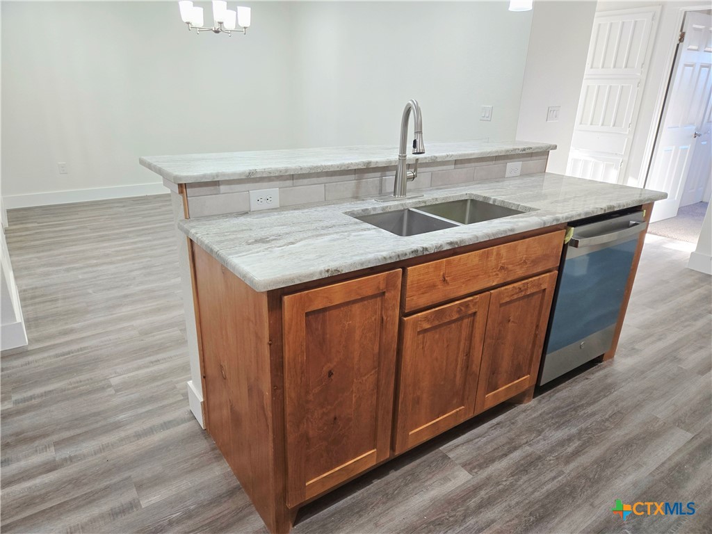 132 County Road 4765 Kempner, TX 76539 - Photo 18 of 36 a kitchen with granite countertop a sink and cabinets