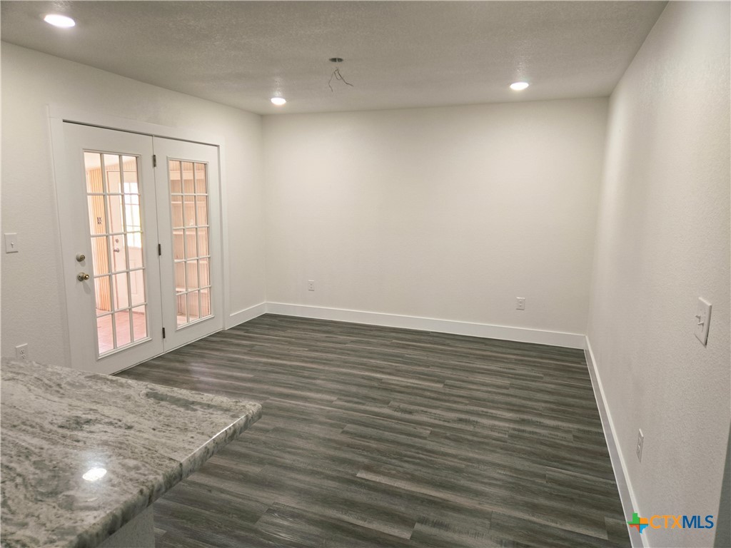 132 County Road 4765 Kempner, TX 76539 - Photo 19 of 29 an empty room with wooden floor and windows
