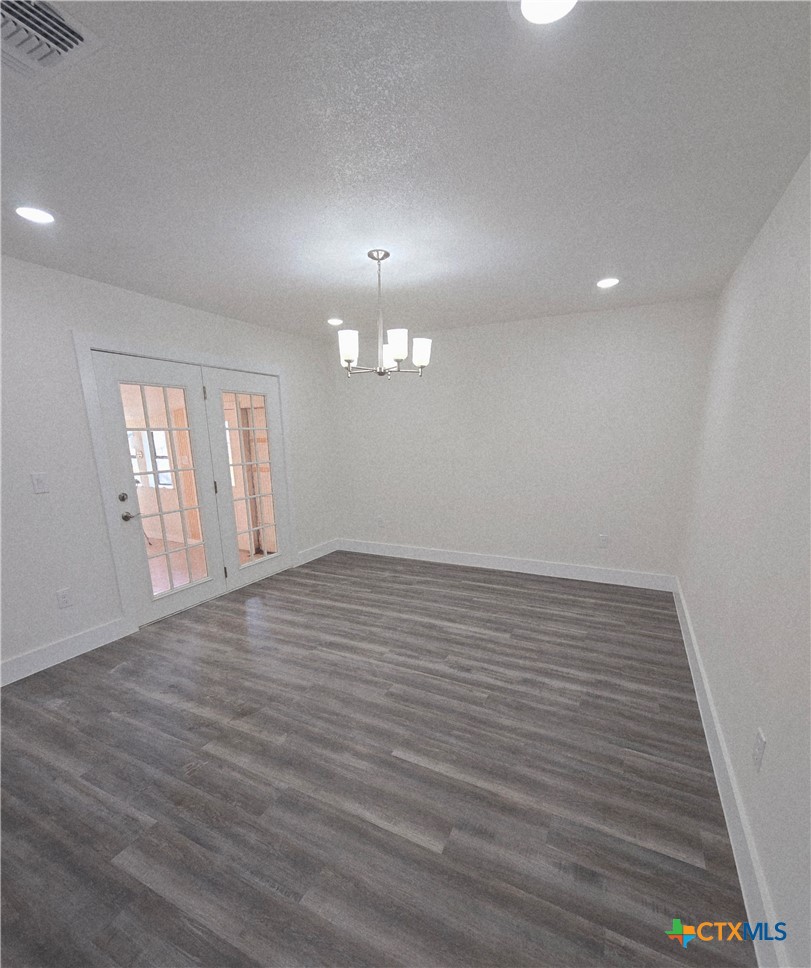 132 County Road 4765 Kempner, TX 76539 - Photo 20 of 36 an empty room with wooden floor and windows