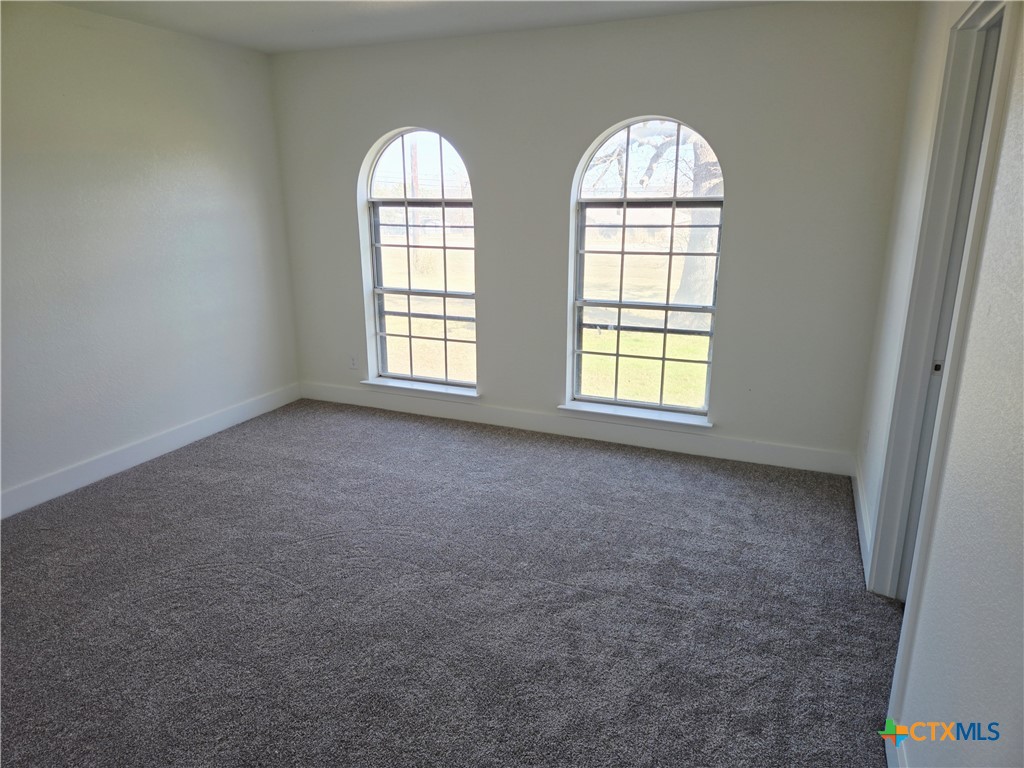 132 County Road 4765 Kempner, TX 76539 - Photo 20 of 29 an empty room with windows and mirror