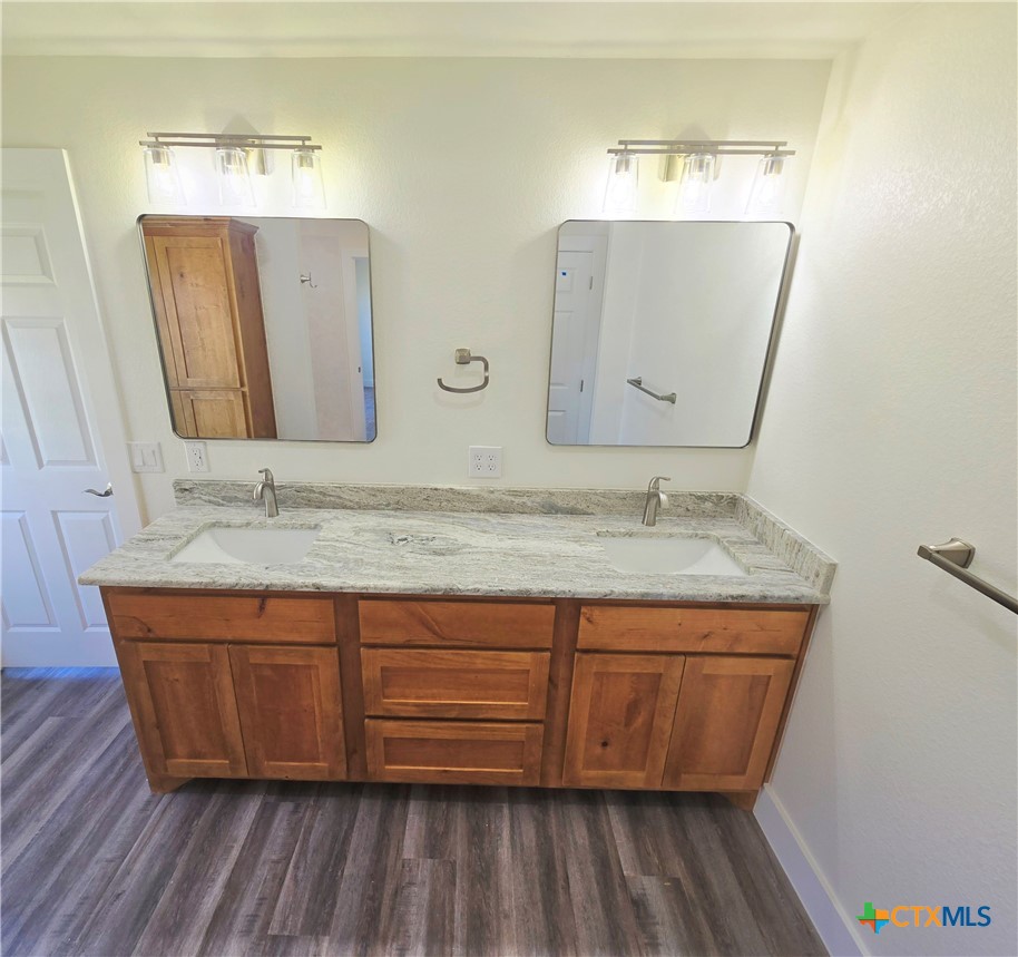 132 County Road 4765 Kempner, TX 76539 - Photo 24 of 36 a bathroom with a granite countertop sink and a mirror