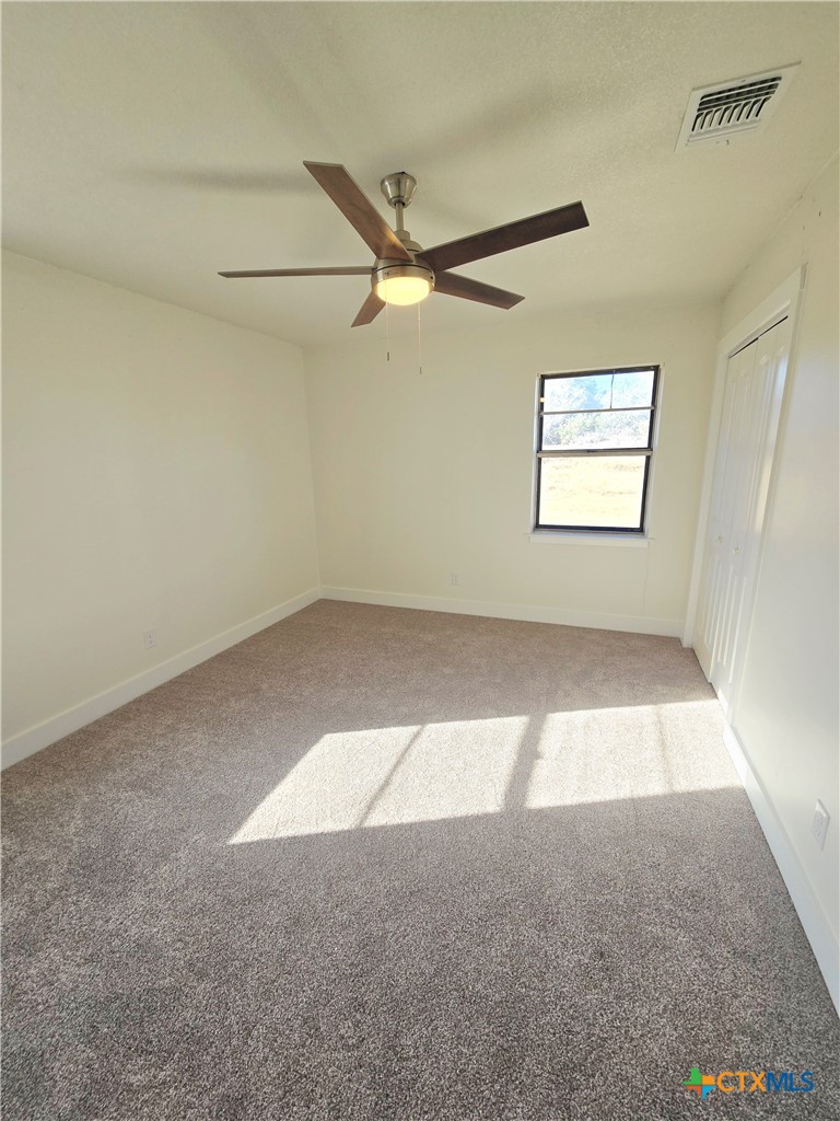 132 County Road 4765 Kempner, TX 76539 - Photo 30 of 36 an empty room with a window and a ceiling fan