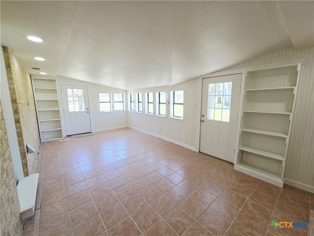 132 County Road 4765 Kempner, TX 76539 - Photo 33 of 36 a view of an empty room with a window and a kitchen