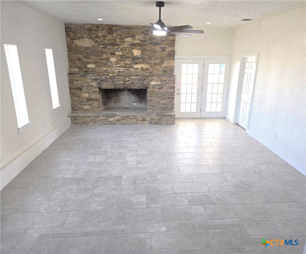 132 County Road 4765 Kempner, TX 76539 - Photo 10 of 36 an empty room with windows and fireplace