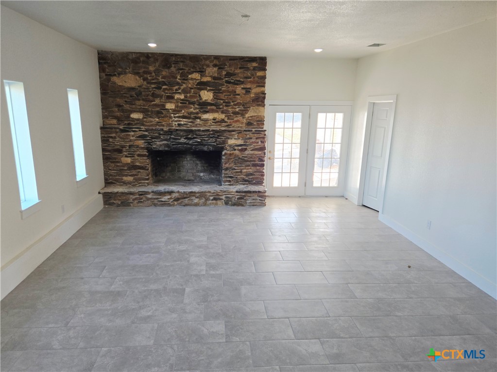 132 County Road 4765 Kempner, TX 76539 - Photo 10 of 29 a view of an empty room with a fireplace and a window