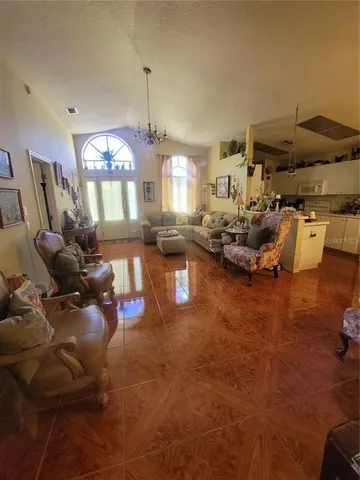 a living room with furniture and a chandelier