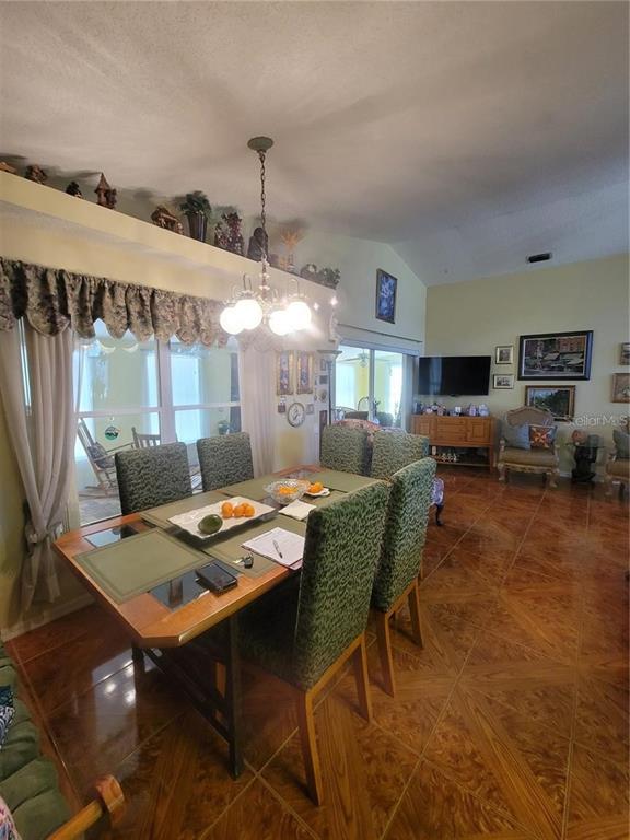 8430 Madrid Road Weeki Wachee, FL 34613 - Photo 4 of 11 a dining room with furniture and window
