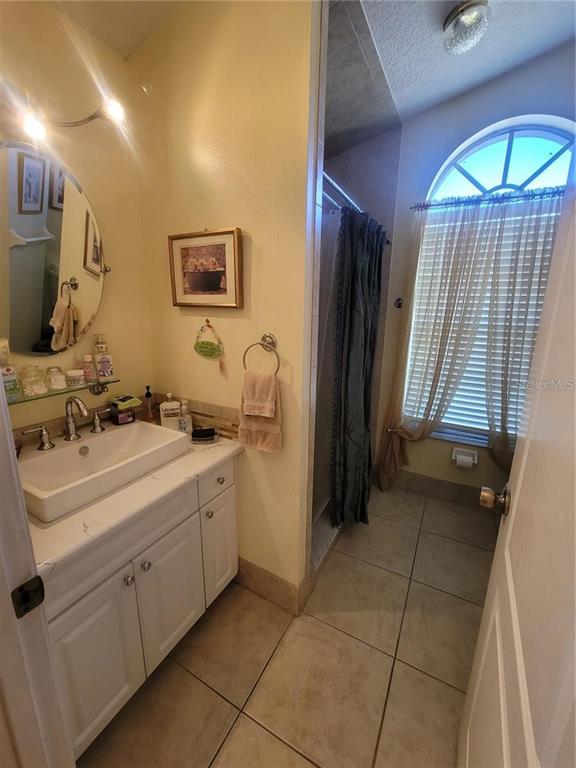 8430 Madrid Road Weeki Wachee, FL 34613 - Photo 8 of 11 a bathroom with a sink and a mirror
