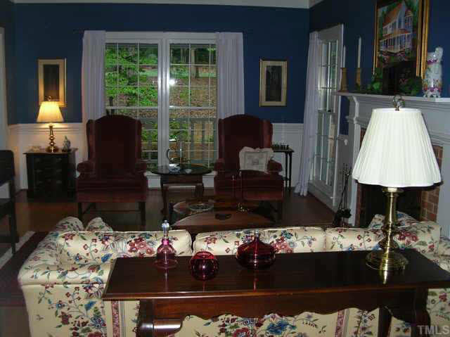 8821 Stage Ford Road Raleigh, NC 27615 - Photo 4 of 10 a living room with furniture and a lamp