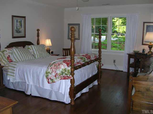 8821 Stage Ford Road Raleigh, NC 27615 - Photo 5 of 10 a bedroom with a bed and a window