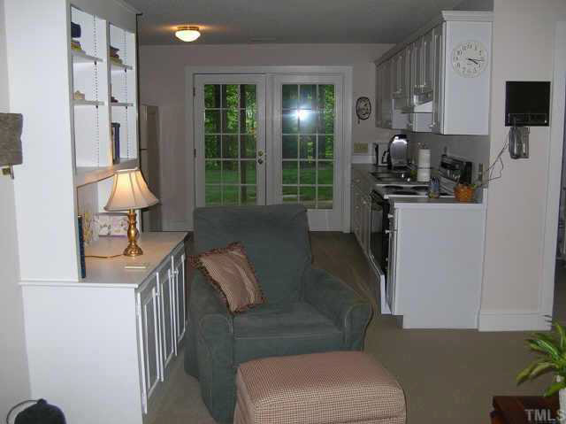 8821 Stage Ford Road Raleigh, NC 27615 - Photo 7 of 10 a living room with furniture and a fireplace