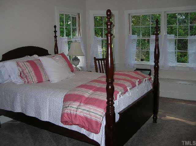 8821 Stage Ford Road Raleigh, NC 27615 - Photo 8 of 10 a bedroom with a bed and window