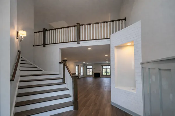 a view of entryway and hall with wooden floor