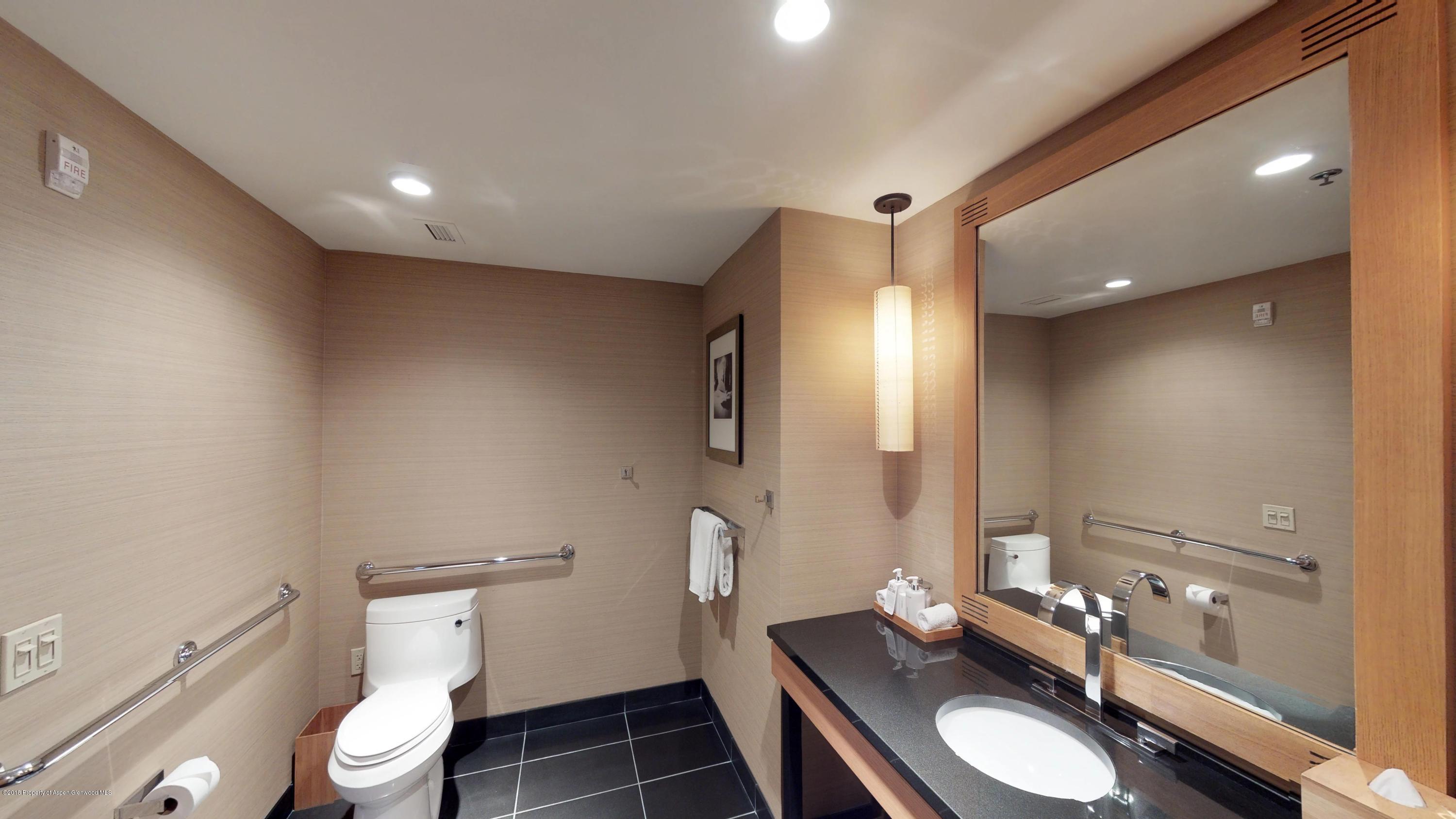 130 Wood Road, Unit 803 Snowmass Village, CO 81615 - Photo 3 of 10 a bathroom with a toilet a sink and mirror