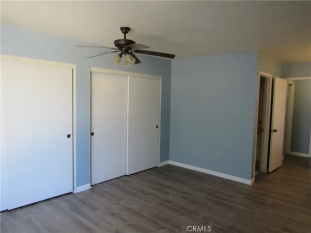 a view of room with hardwood floor and hallway