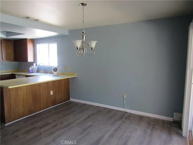 a room with a sink cabinets and wooden floor