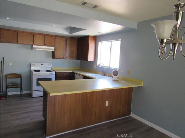 a kitchen that has a sink and a stove in it