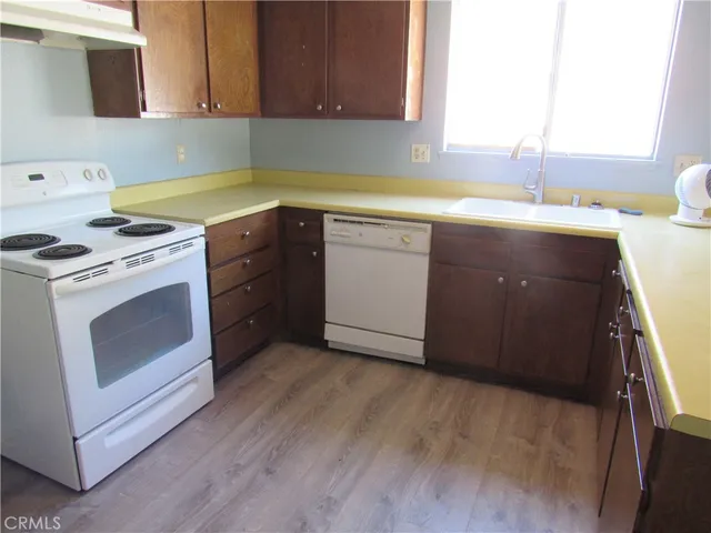 a kitchen with a stove sink and cabinets