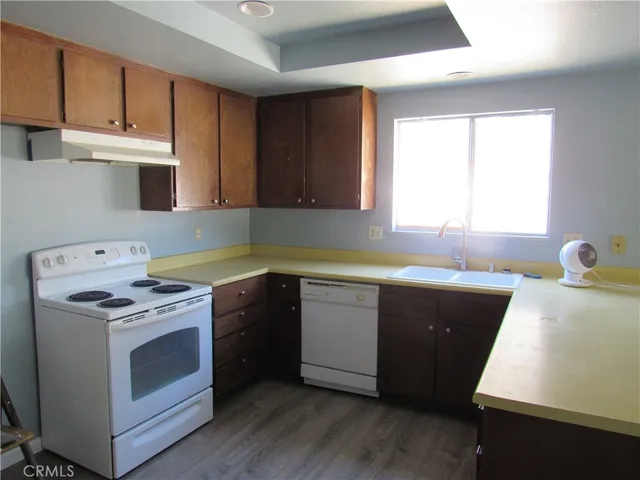 a kitchen with a stove a sink and a microwave