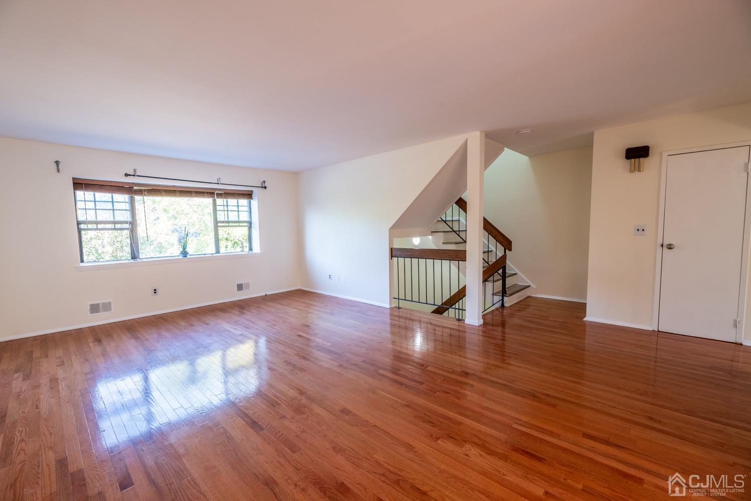 7101 Hana Road Edison, NJ 08817 - Photo 12 of 77 a view of empty room with wooden floor and fan