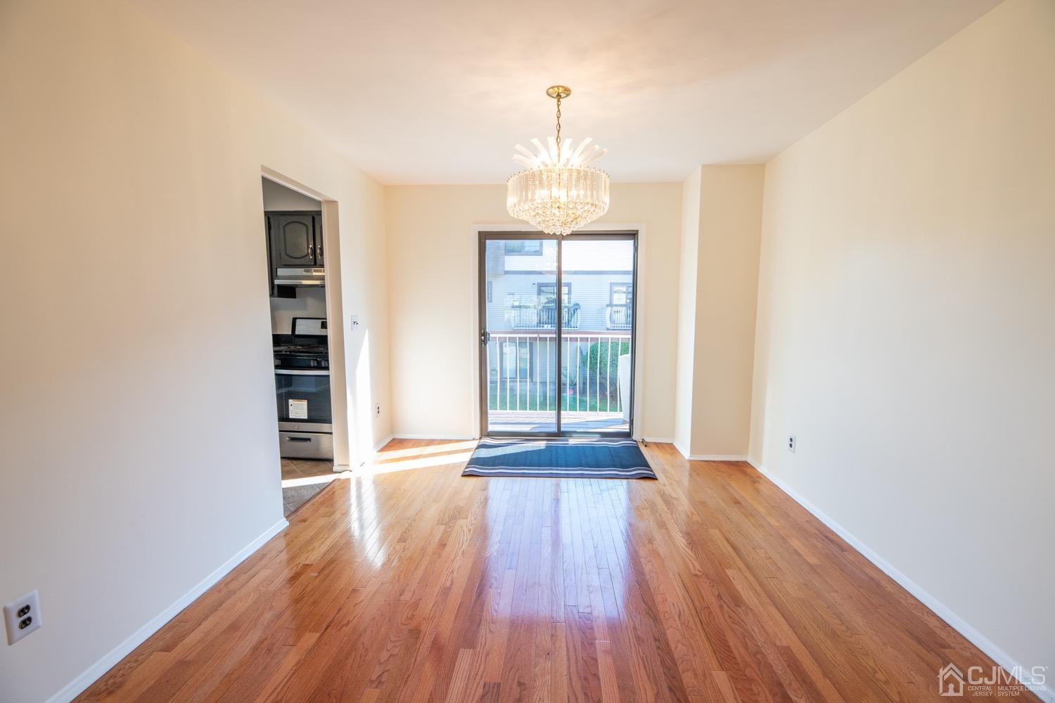 7101 Hana Road Edison, NJ 08817 - Photo 15 of 77 a view of an empty room with wooden floor and a window