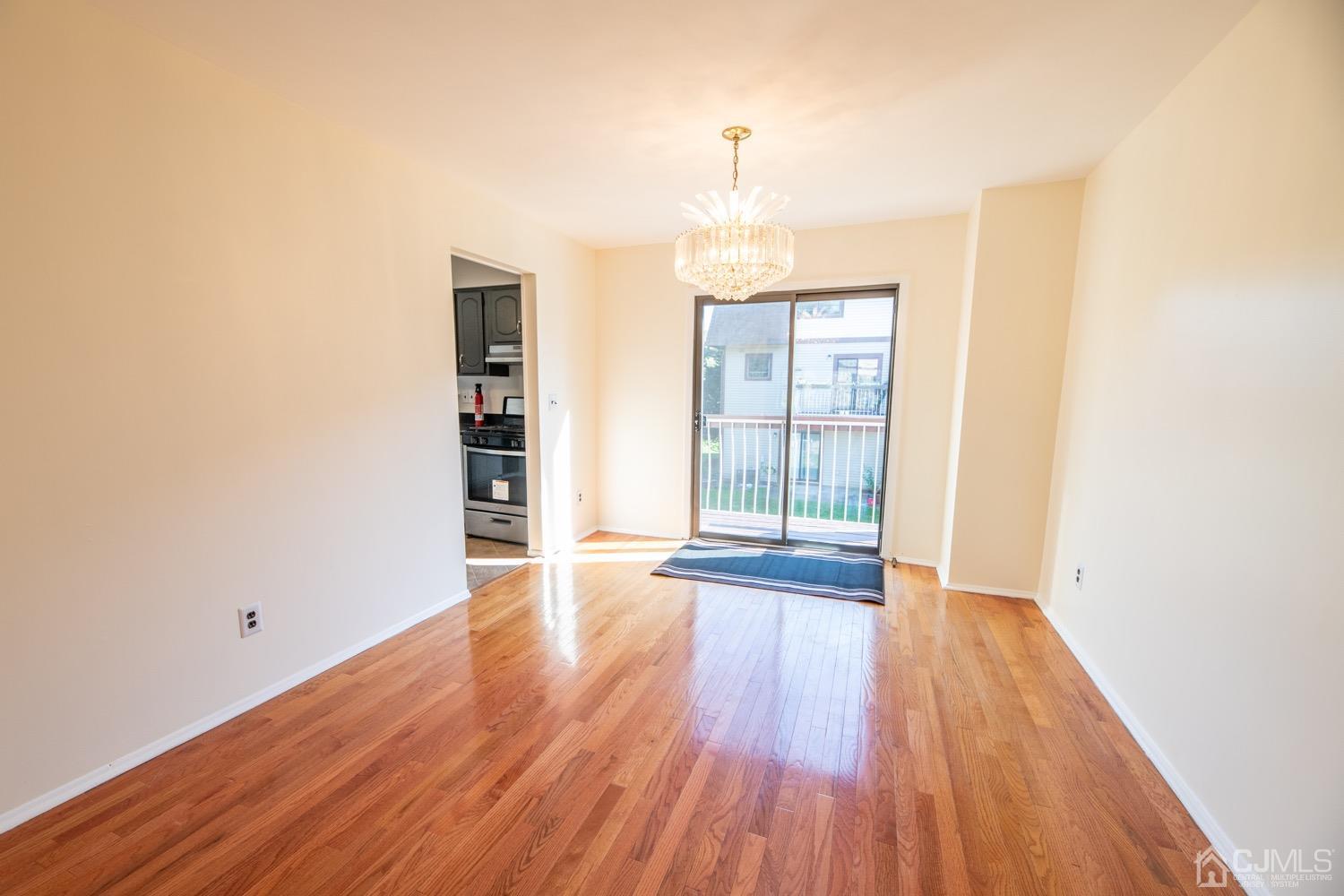 7101 Hana Road Edison, NJ 08817 - Photo 18 of 77 an empty room with wooden floor and windows
