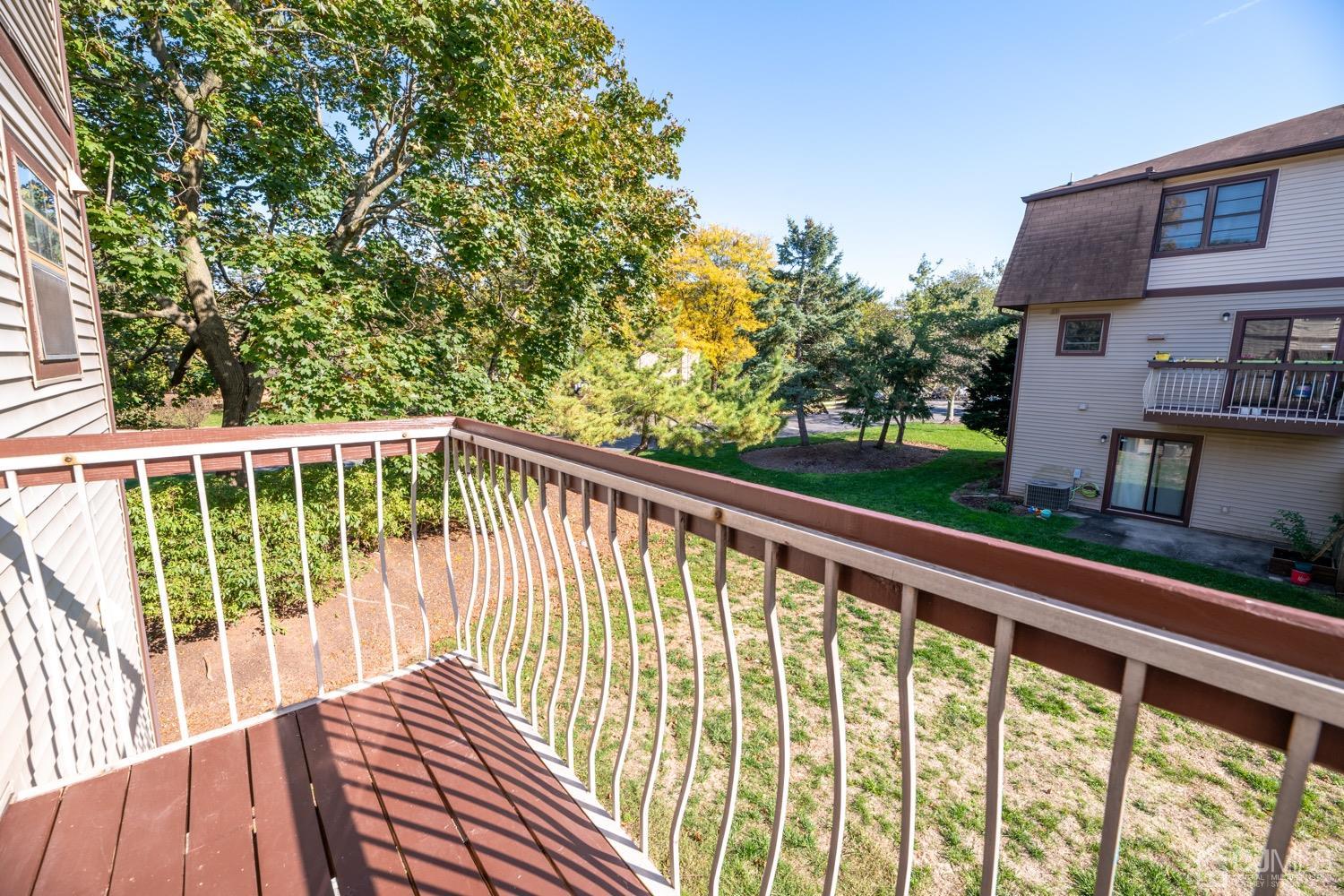 7101 Hana Road Edison, NJ 08817 - Photo 23 of 77 a view of balcony with wooden floor and fence