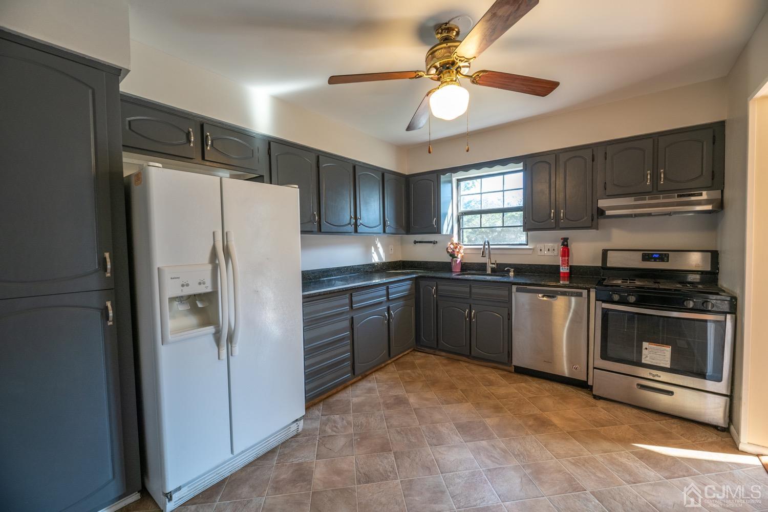 7101 Hana Road Edison, NJ 08817 - Photo 26 of 77 a kitchen with granite countertop a refrigerator stove and sink